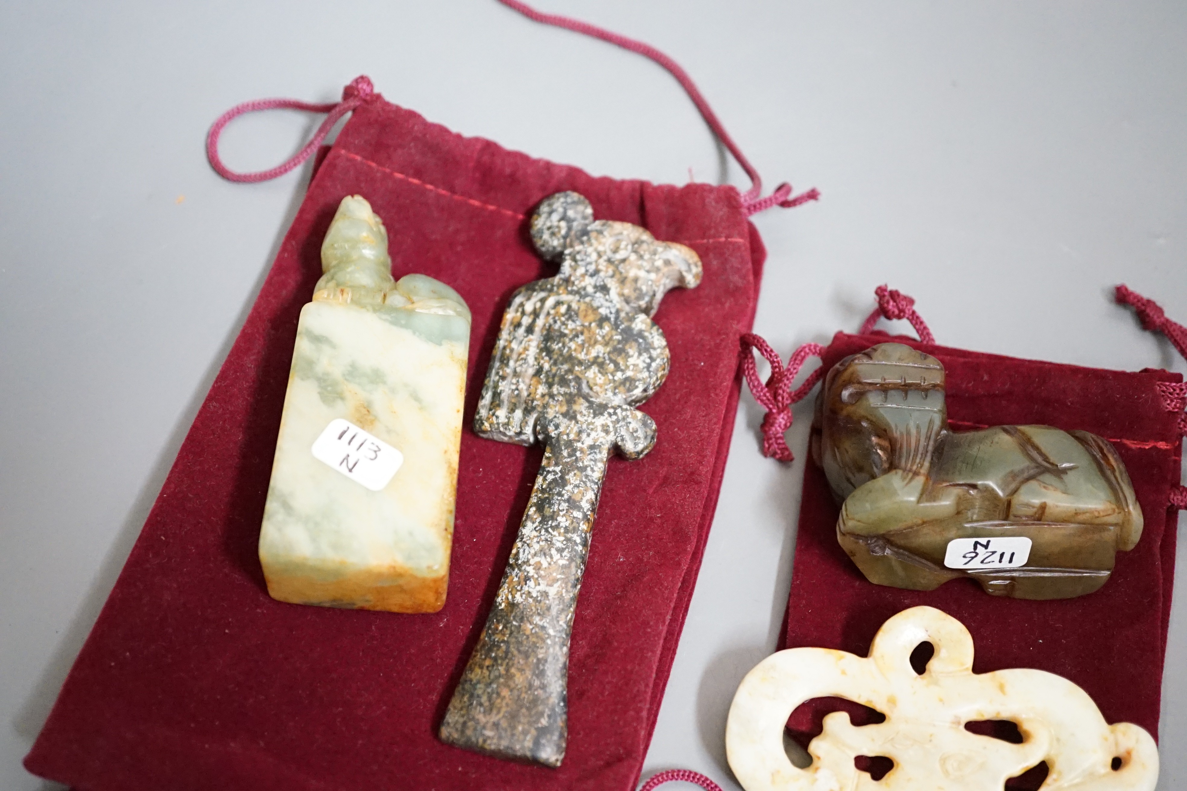 Four jade items: a mythical beast, a seal, a ritual image and a dragon